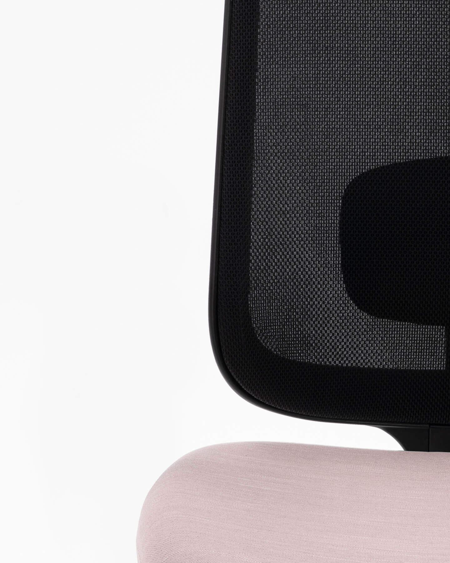 A Close Up Shot Of An Armless Task One Black Frame Office Chair And Pink Seat