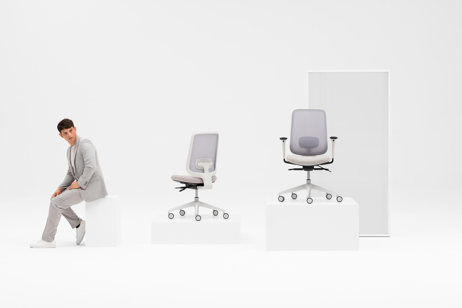 Person Sitting Down Looking at Two Grey Frame Office Chairs