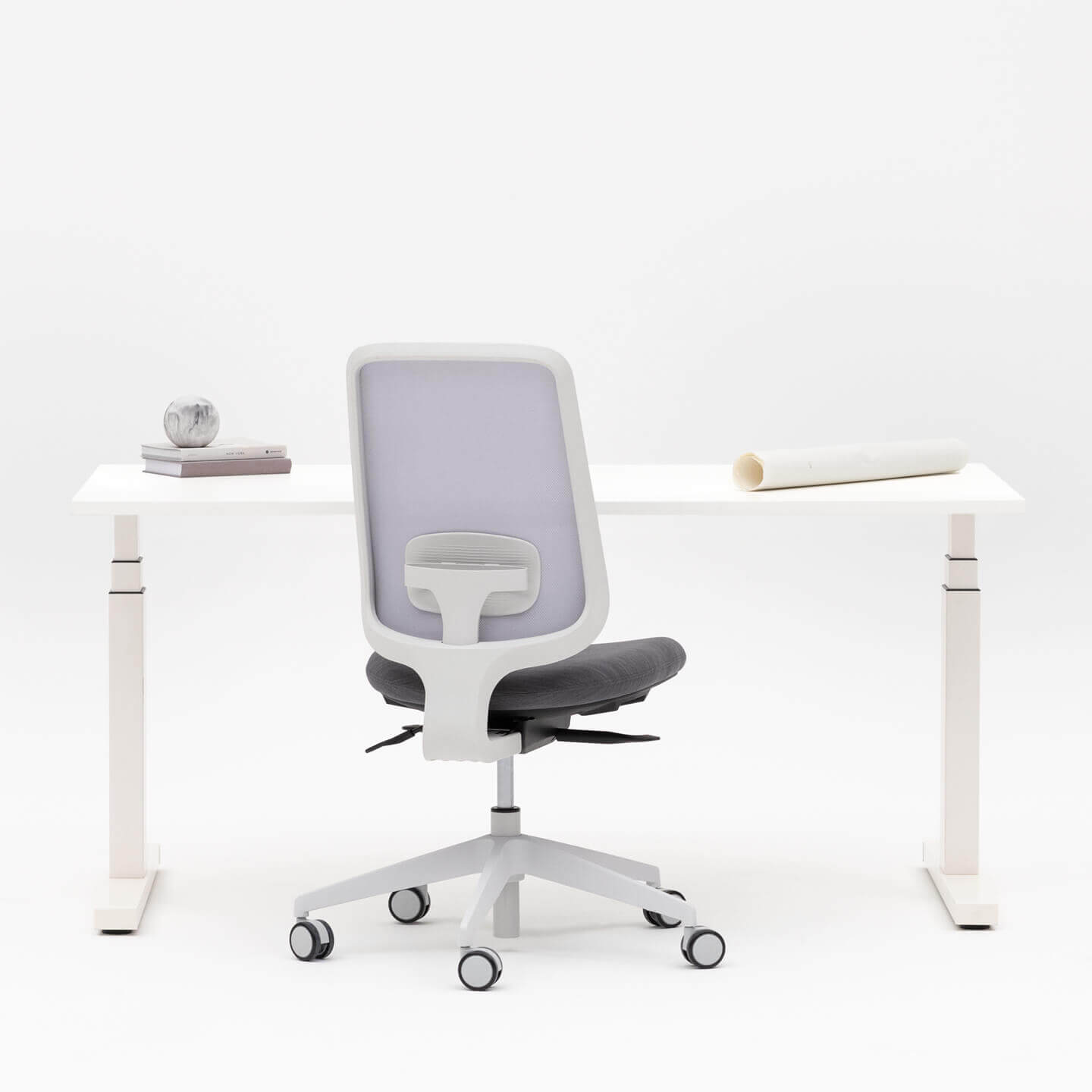 Task One Grey Frame Office Chair With No Arms And Charcoal Seat Facing A Desk One Height Adjustable White Desk