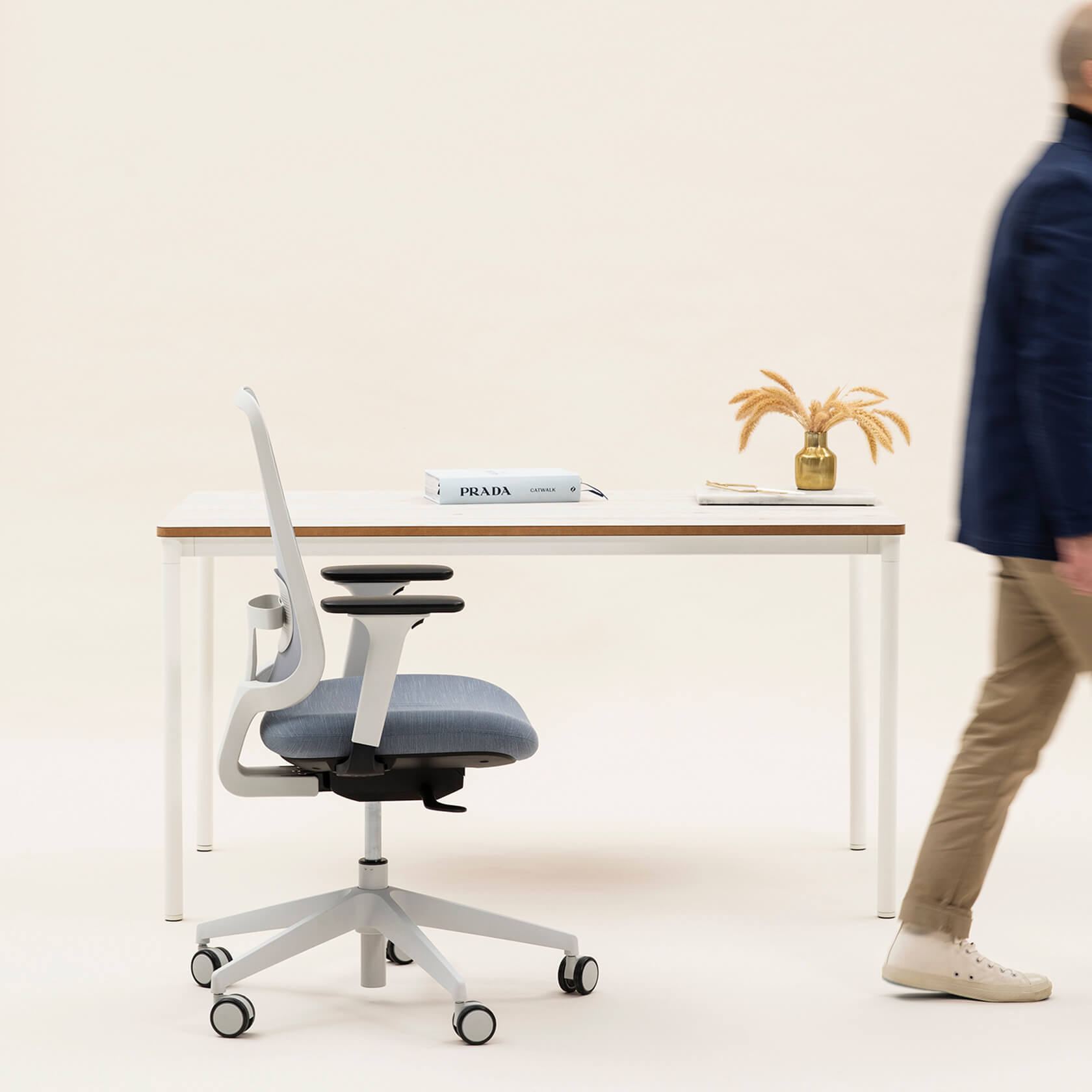 Person Walking Away From A Desk And Task One Grey Frame Office Chair With Arms And Bluestone Seat