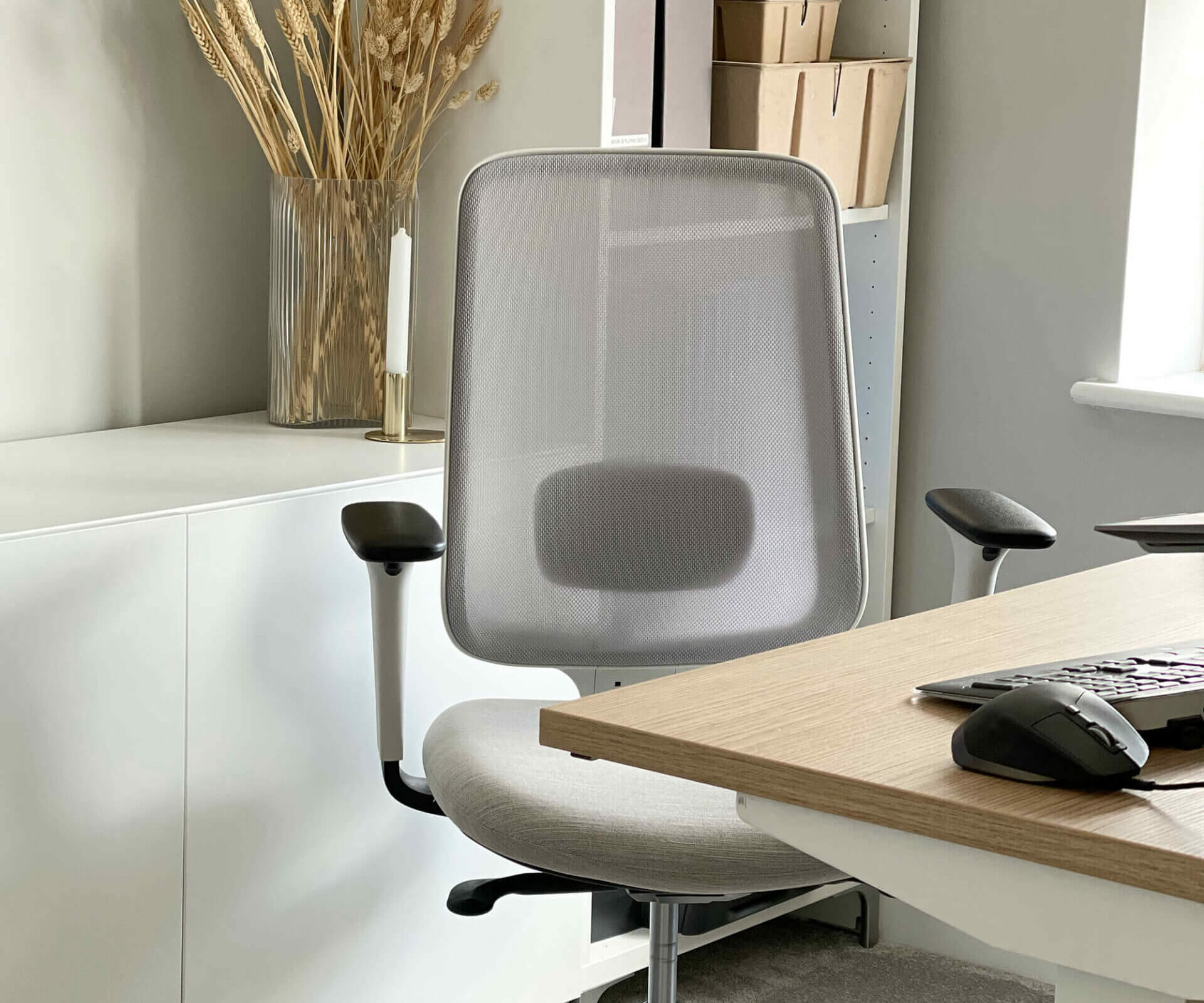 Close Up of the Task One Grey Frame Office Chair With Arms in An Office Setting